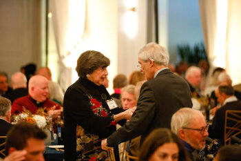 A candid photo of attendees talking at the George Eastman Circle Annual Member Dinner.