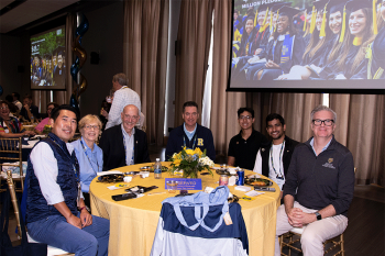 Group photo of people seated at a table