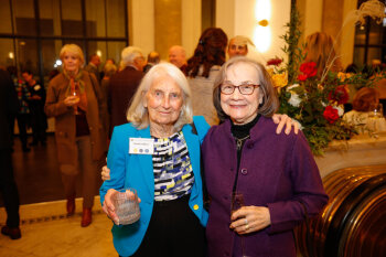 Two female attendees pose for a photo at the George Eastman Circle Annual Member Dinner.