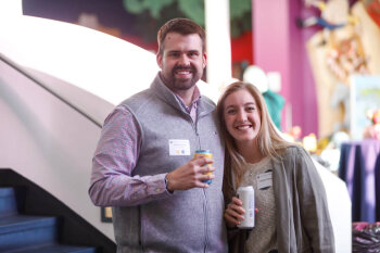 A man and woman pose for a photo at the George Eastman Circle Family Celebration, held on April 27, 2023 within Rochester New York.