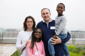 A family of four pose for a photo at the George Eastman Circle Family Celebration, held April 30, 2023, within Washington, DC.