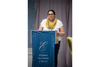 A woman speaking at the lecturn