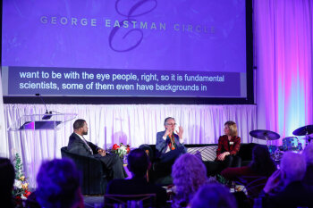 Three speakers having a conversation on stage at the George Eastman Circle Annual Member Dinner.