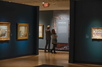 2 people looking at an exhibit at the MAG