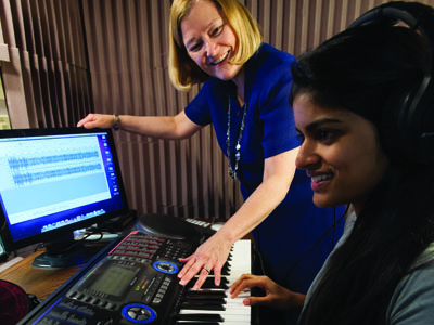 Elizabeth West Marvin, Eastman School of Music professor of music theory and brain and cognitive sciences, with Vasha Nair '14E in a soundproof booth