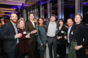 A group of people posing for a photo at the GEC Holiday party