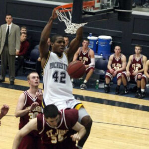 Jon Onyiriuka ’08 dunking a basketball into the hoop during a basketball game