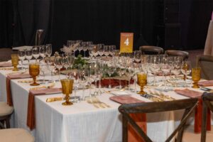 table set with many wine glasses