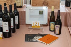 lot 121 display with bottles of wine and digital display with lot description
