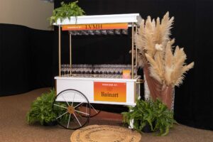 white cart with many empty glasses for wine and champagne