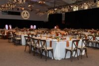 angled view of the room with many tables set up with many empty wine glasses