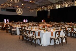 angled view of the room with many tables set up with many empty wine glasses