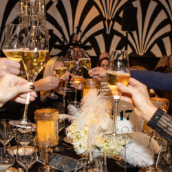 Hands holding champaign that are doing cheers