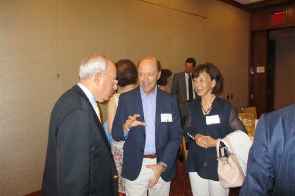 three people mingling at event