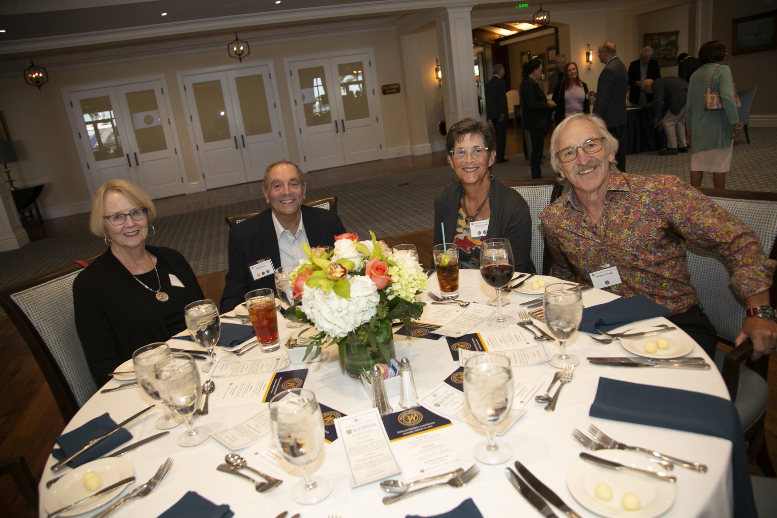 People seated at a table posing for a camera