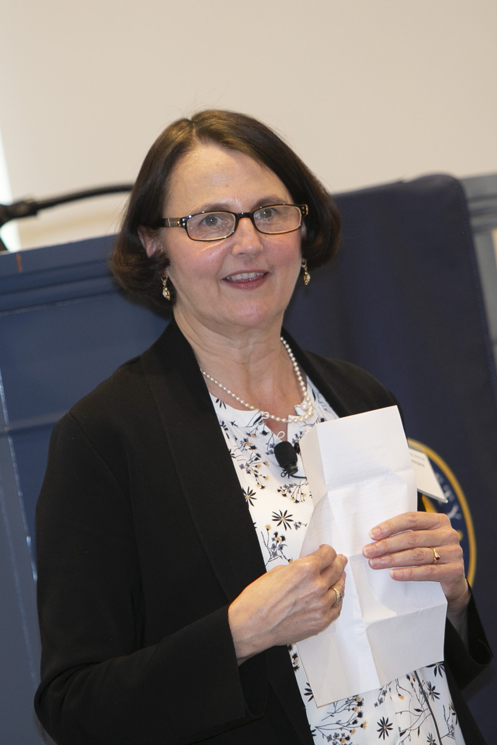 A woman holding a piece of paper