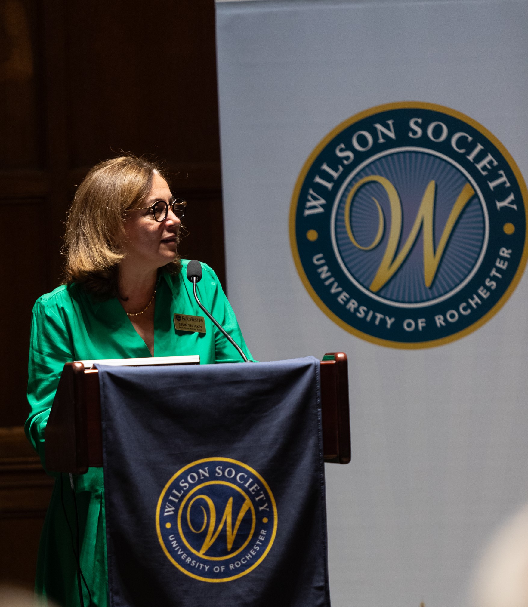 Dean Yeltekin speeking on a podium