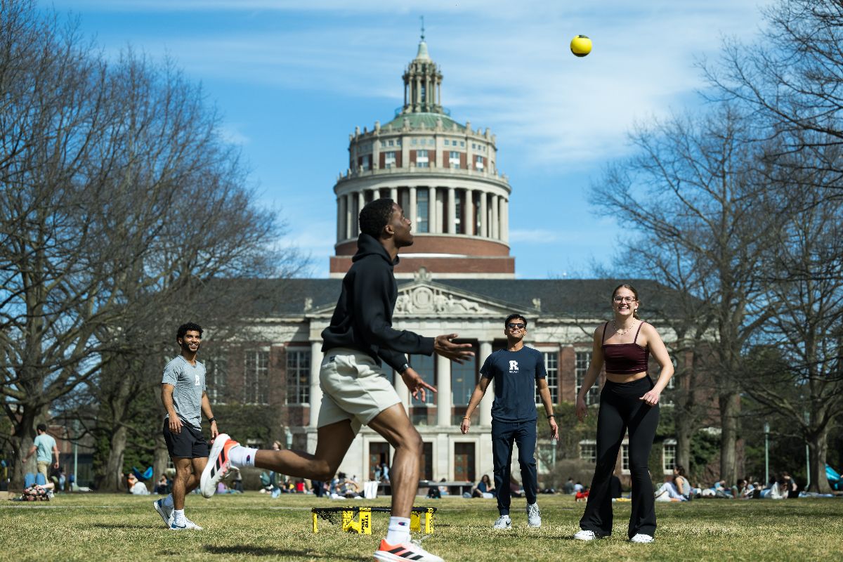 A group of students play spikeball on the Eastman Quad.