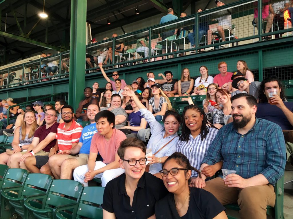 A group of University of Rochester graduate students attending a Rochester Red Wings baseball game on Pride Night.