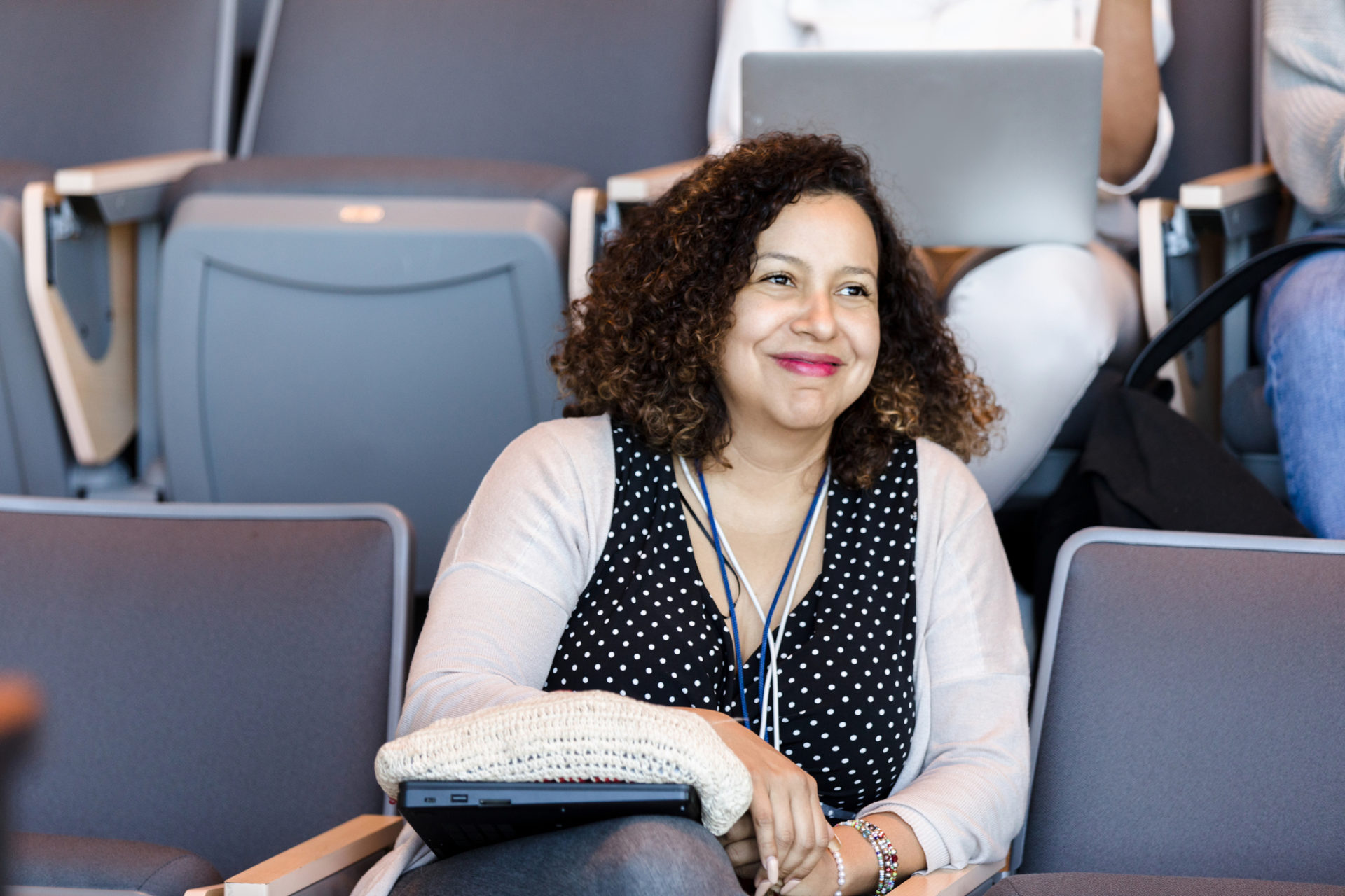 Confident woman sitting in an auditorium chair