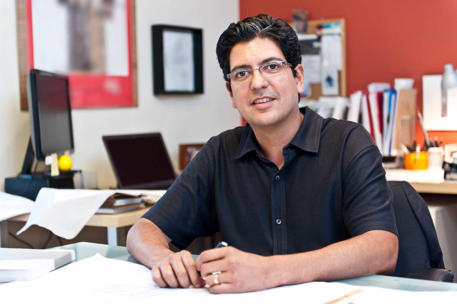 portrait of man in an office sitting at a desk