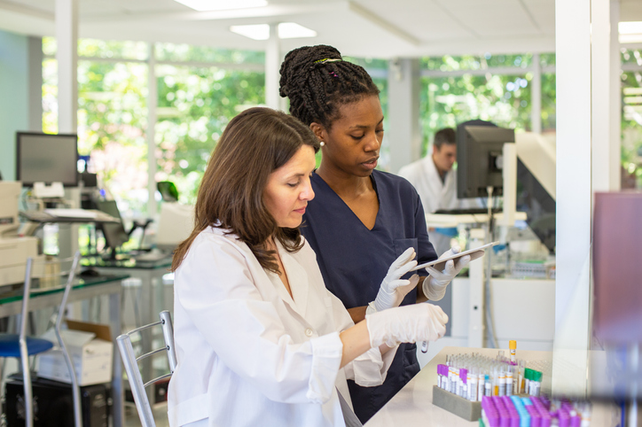 Female Pathologist and Technician Organizing Test Samples