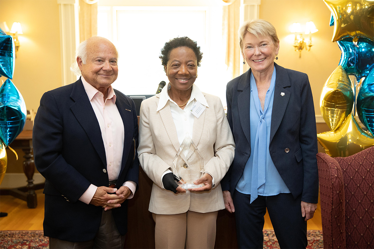 Berthenia Coltrane (center), IT help desk manager, arts, sciences, & engineering IT receives the Witmer Award for Distinguished Service. Left: Larry Kessler, trustee; right: President Sarah Mangelsdorf.