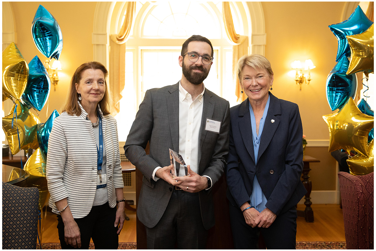 Eiten Freedenberg (center), associate director, Rochester Education Justice Initiative, receives the Meliora Award. Left: Teri D'Agostino; right: President Sarah Mangelsdorf.