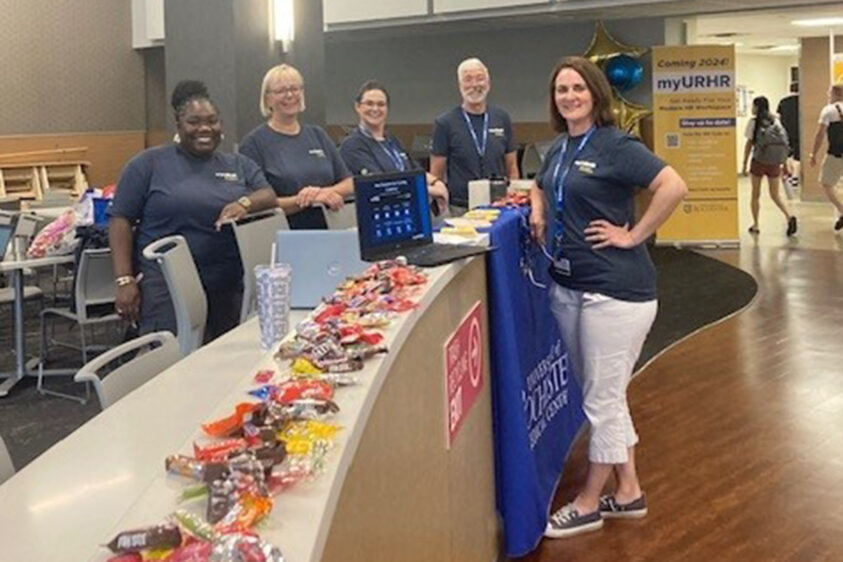 Five members of the myURHR project team at a URMC location giving out promotional goodies promoting myURHR.