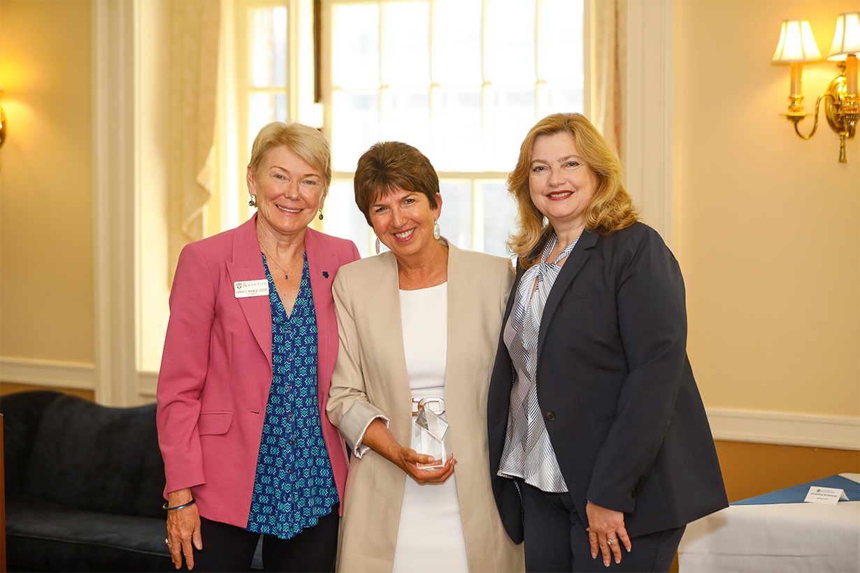 University of Rochester President Sarah Mangelsdorf (left) and University of Rochester Vice President and Chief Human Resources Officer, Kathleen M. Gallucci (right) give Meliora Award winner, Jaqueline Beckerman (center)