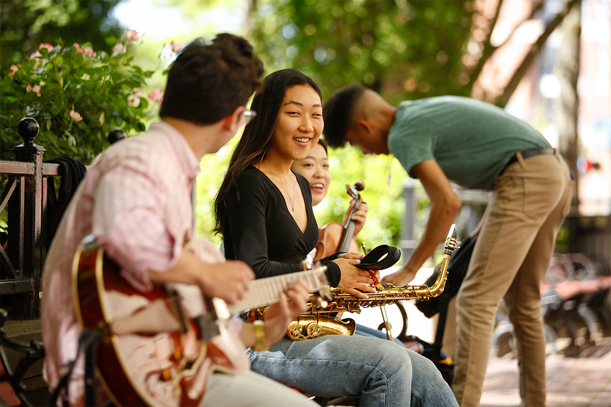 Group of four students with their musical instruments