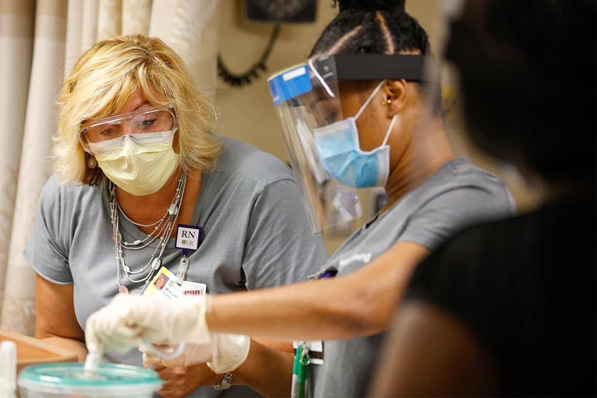 Christine Arnold, program director at the Center for Obstetrics and Gynecology Simulation (COGS) at the University of Rochester Medical Center, briefs nurses, attending physicians and residents before a simulator event.
