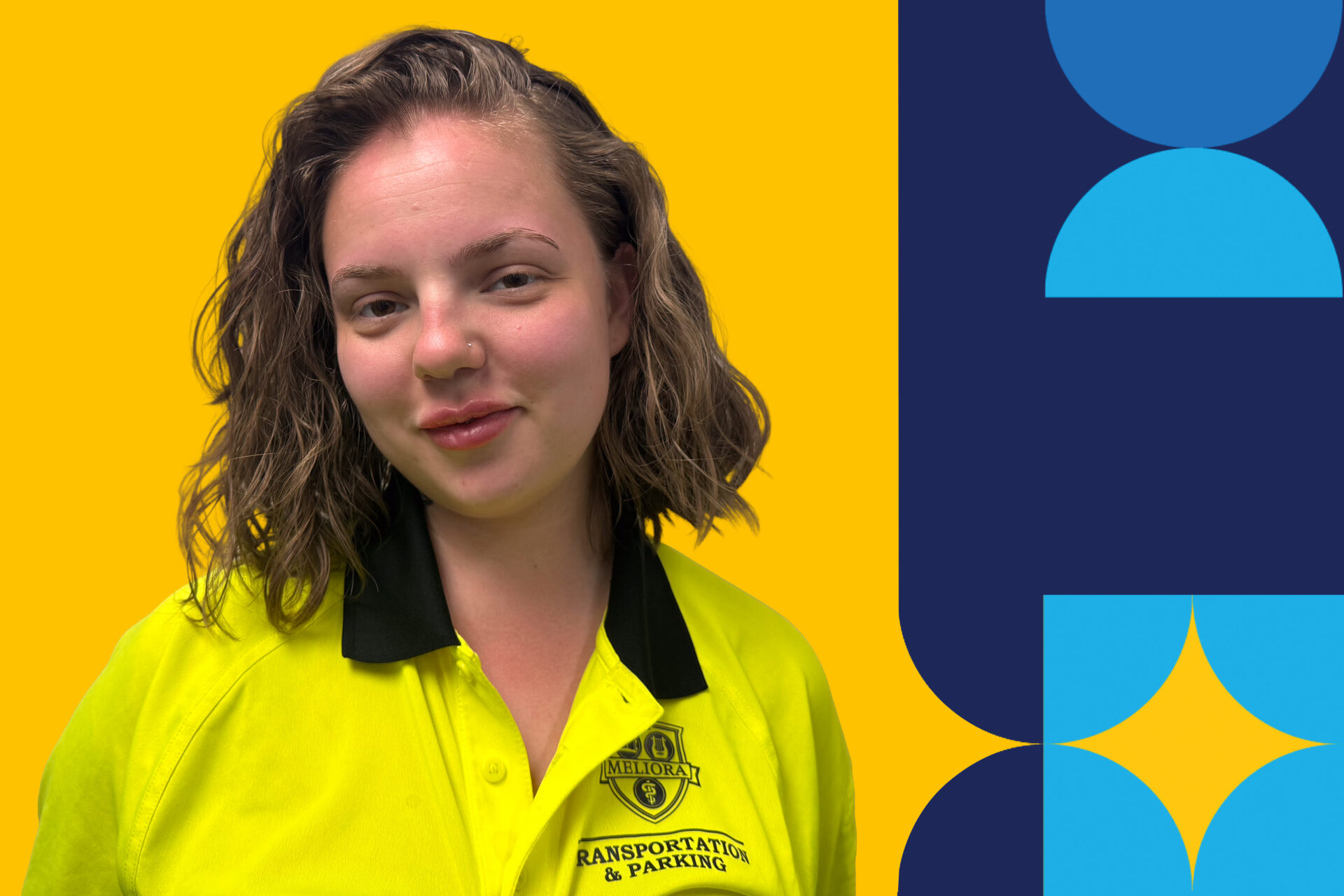 A woman named Hailey Statt bust up wearing a neon polo University of Rochester branded shirt.