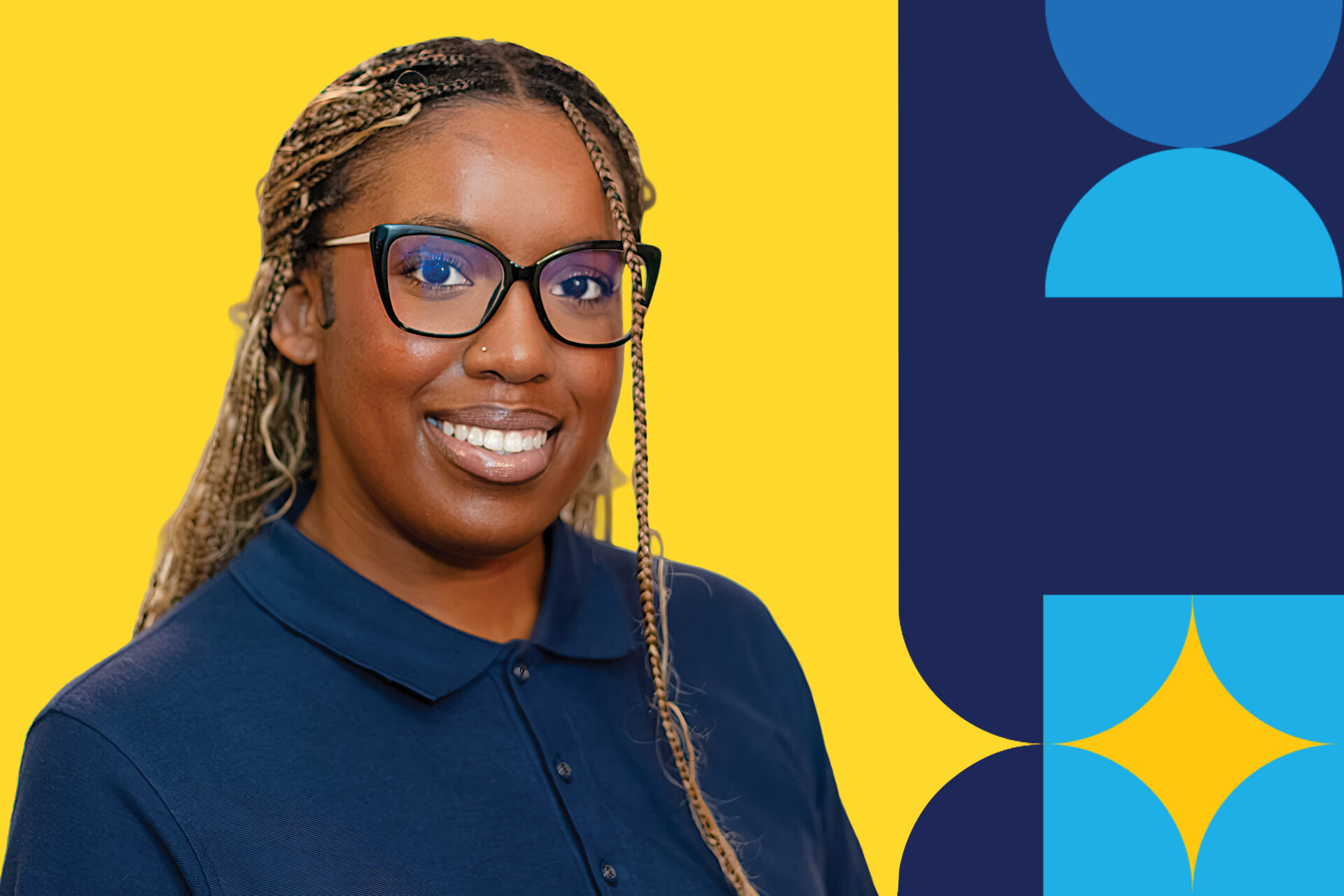 A woman names Alyia Mitchell in a navy button down shirt wearing glasses and smiling brightly in front of a yellow background.
