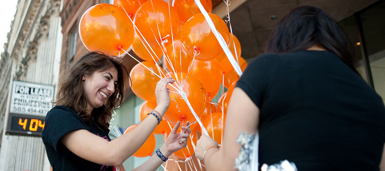 A woman choosing a balloon.