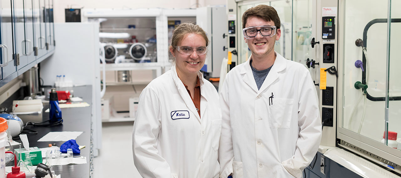 Two students in lab coats.