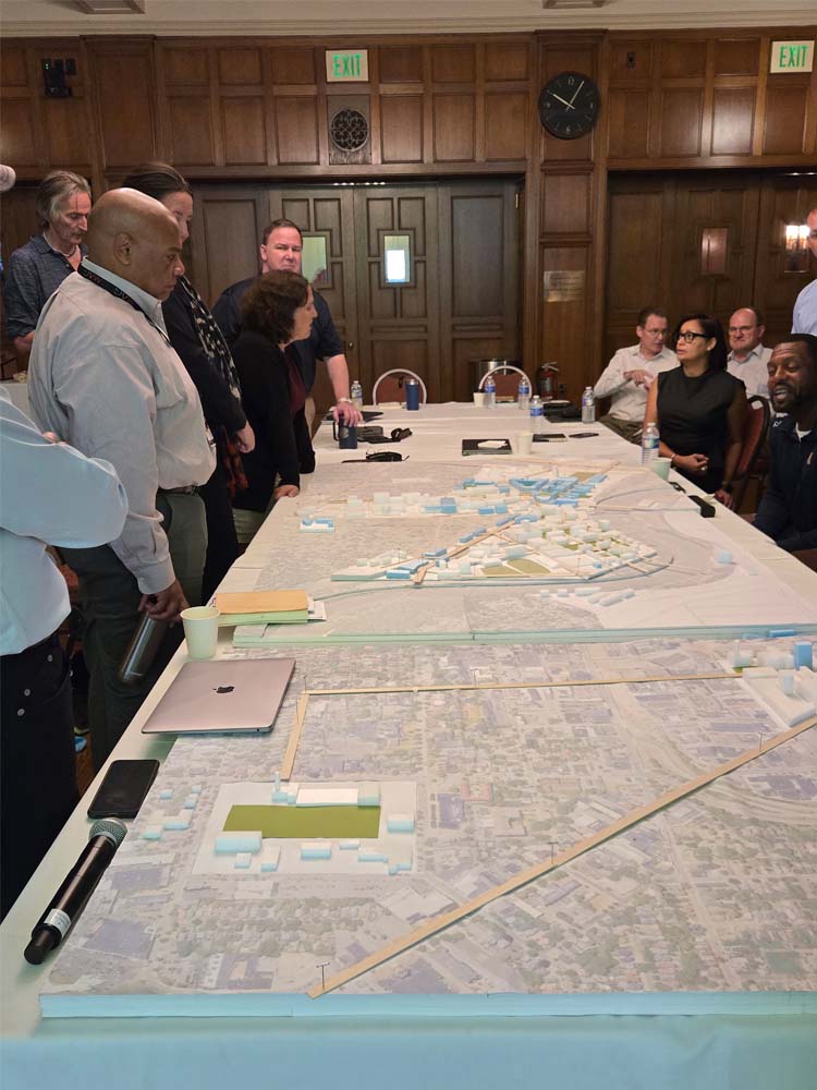 Members of the master planning Executive Steering Committee discuss preliminary framework scenarios with the design and architecture consultants.