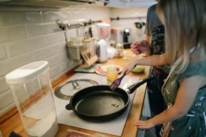 Woman cooking, frying pan on stove
