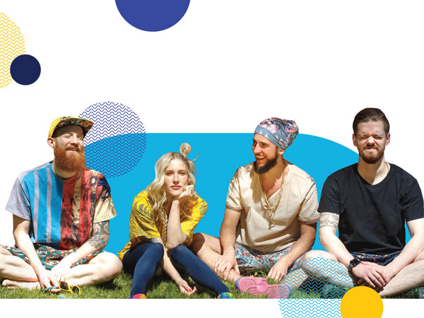 group photo of the band Walk Off the Earth with light blue background and yellow and blue circles