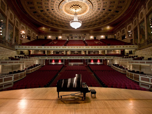inside kodak hall in eastman school of music, seen from stage, looking out into empty audience with piano in foreground