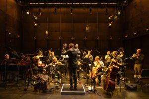 A conductor conducting an orchestra