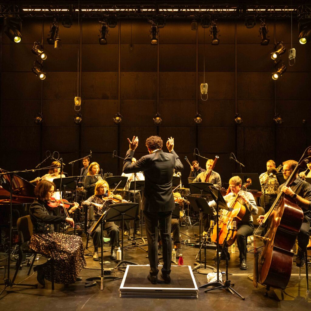 A conductor conducting an orchestra