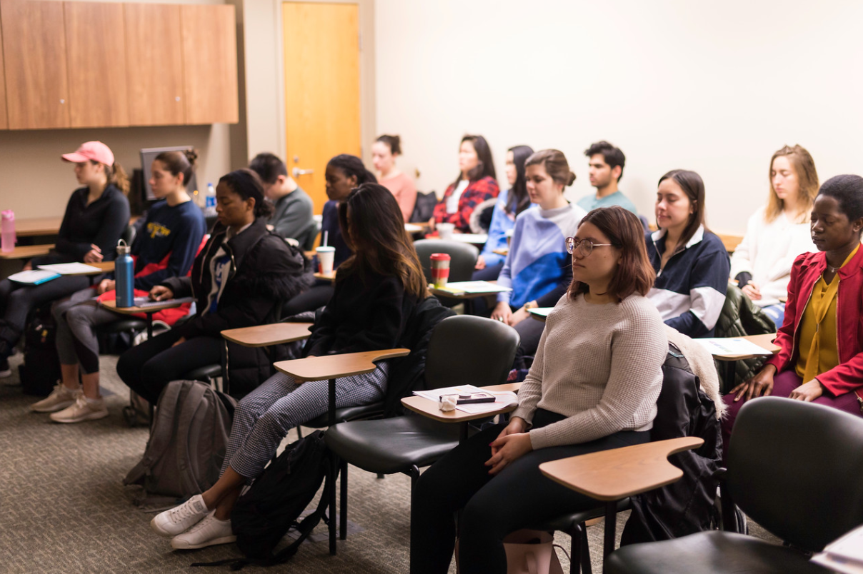 Students in a classroom practicing meditation.
