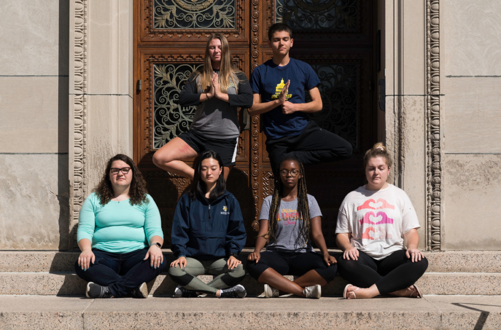 Students meditate on the University of Rochester river campus