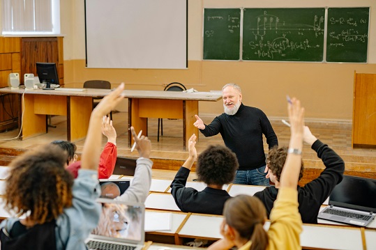 White, male professor teaching a class