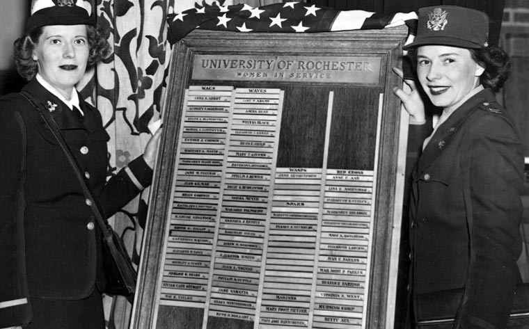 1944 photo of two female members of the armed services holding a plaque