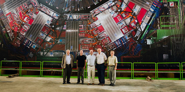 scientists in front of large Hadron collider