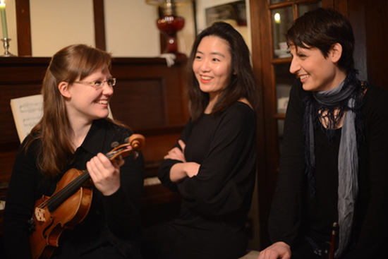 Feature image three women, one holding a violin