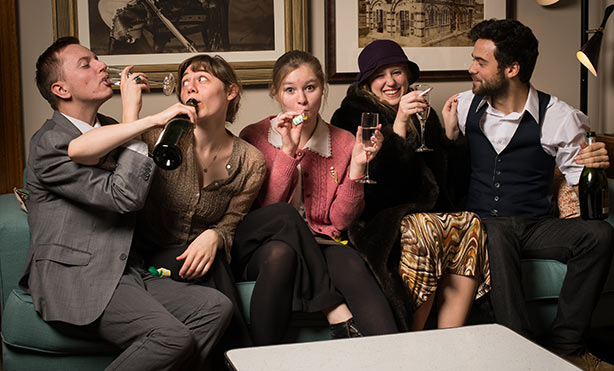 Feature image actors on couch, drinking and partying