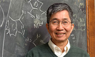 Feature image man by chalkboard with organic chemistry equations
